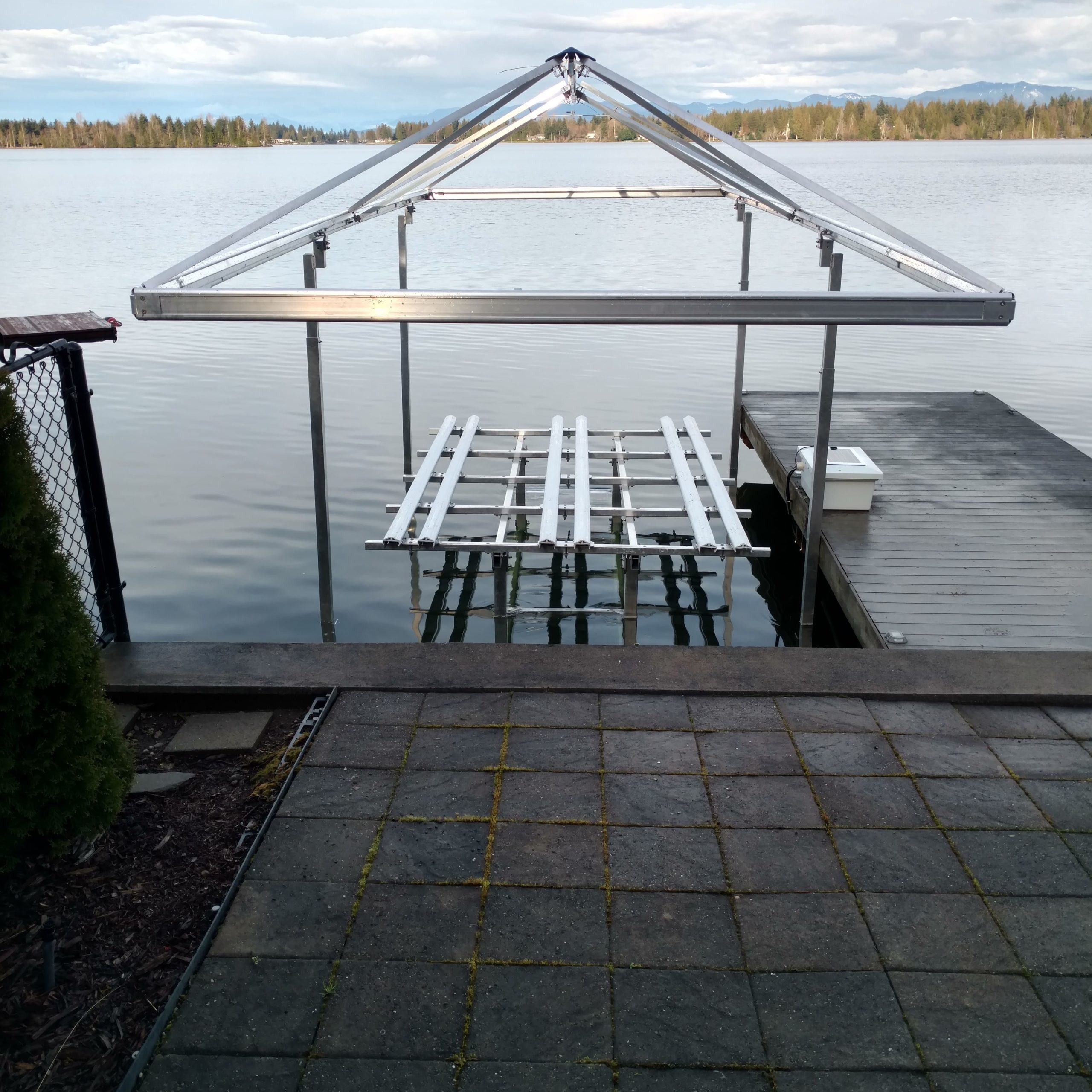 A pontoon boat lift floating or installed above the sea, designed for convenient storage and access to boats.