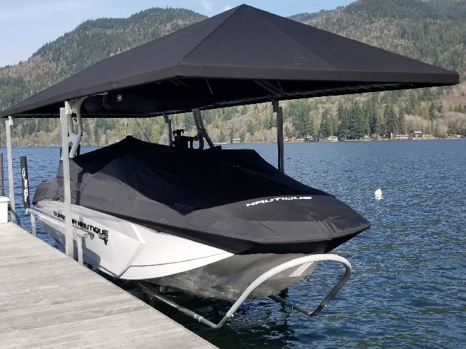 Jet ski positioned on the hydraulic lift with a black top cover for sun protection.